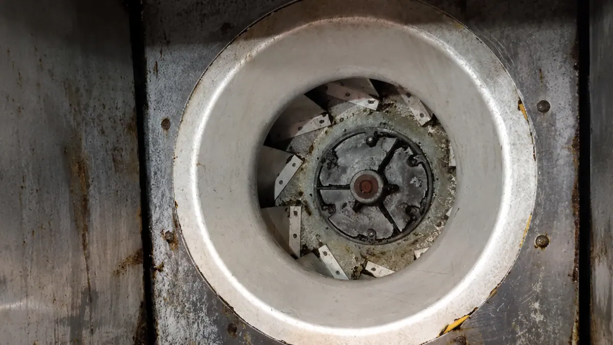 The same kitchen hood exhaust fan after cleaning, restored to bare stainless steel