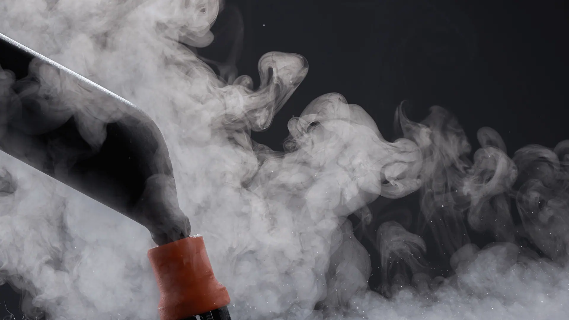 Close-up of a professional steam cleaning wand in use